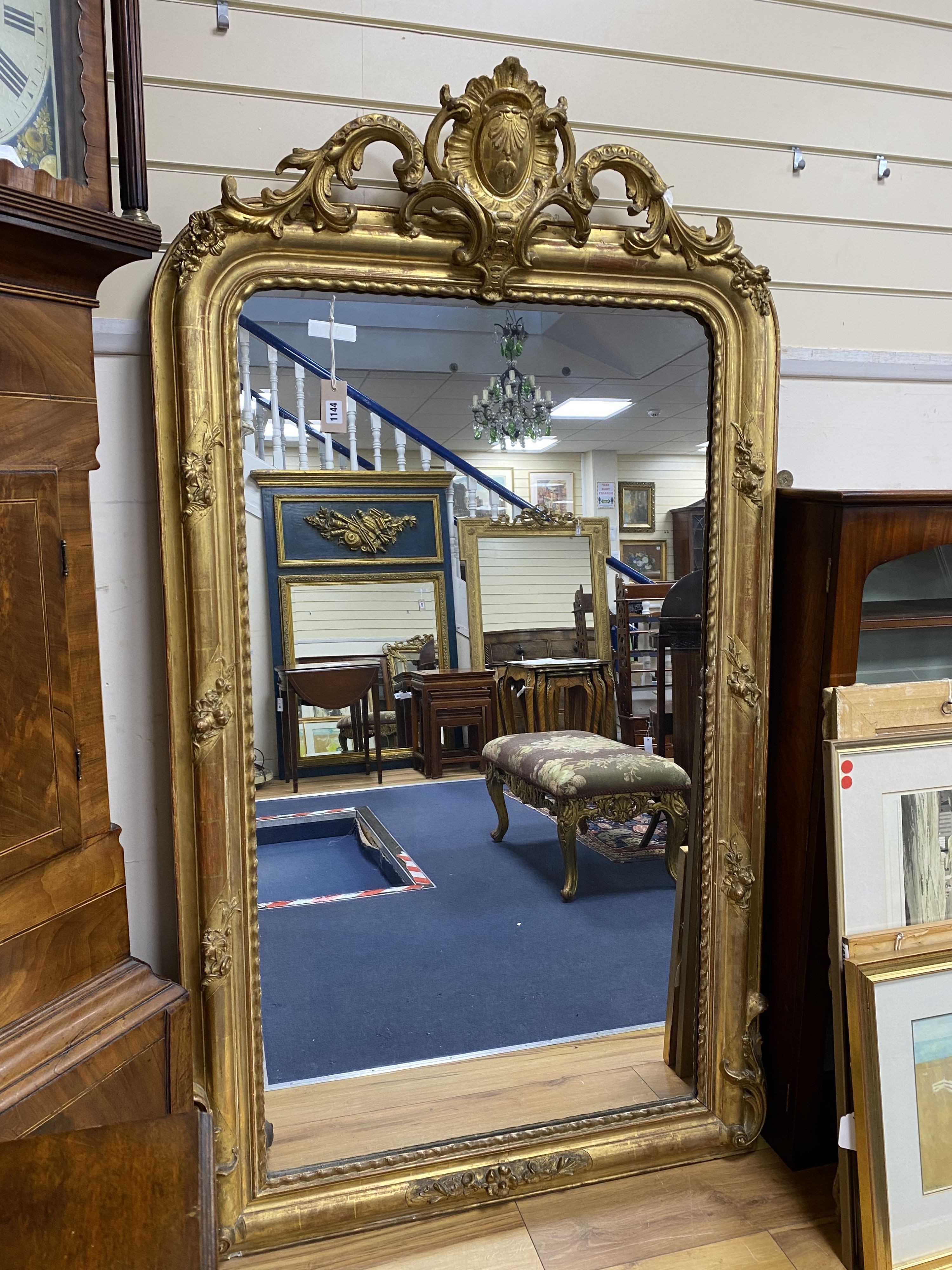 A 19th century French overmantel mirror, giltwood and gesso with channelled frame and scroll with cabochon crest detail, width 98cm, height 164cm